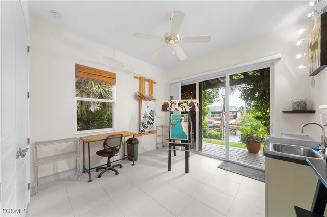 a view of a livingroom with workspace and a window