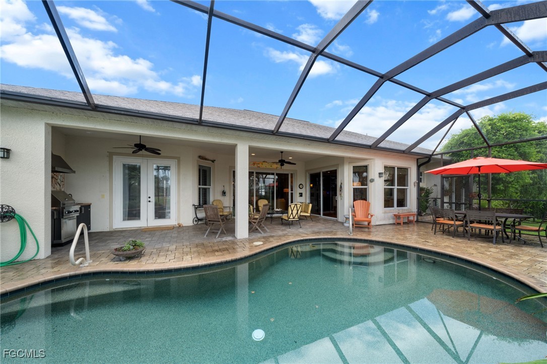 4424 North Bay Circle North Fort Myers, FL 33903 - Photo 35 of 43 a view of a patio with table and chairs under an umbrella