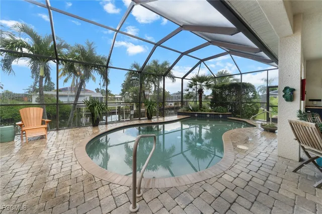 a outdoor view with a swimming pool and sitting space