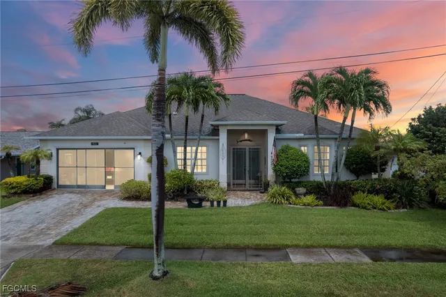 a front view of a house with a garden and yard