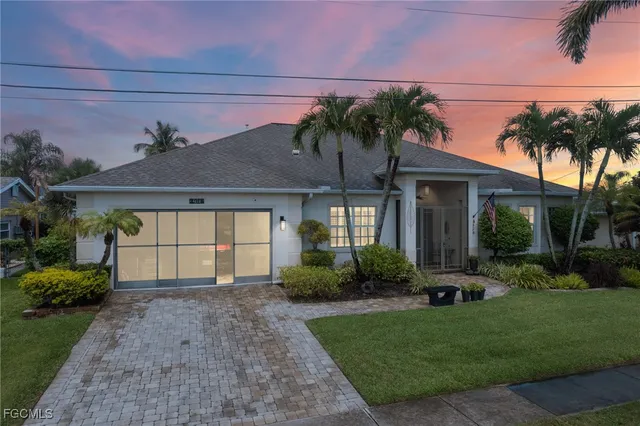 a front view of a house with a garden and plants