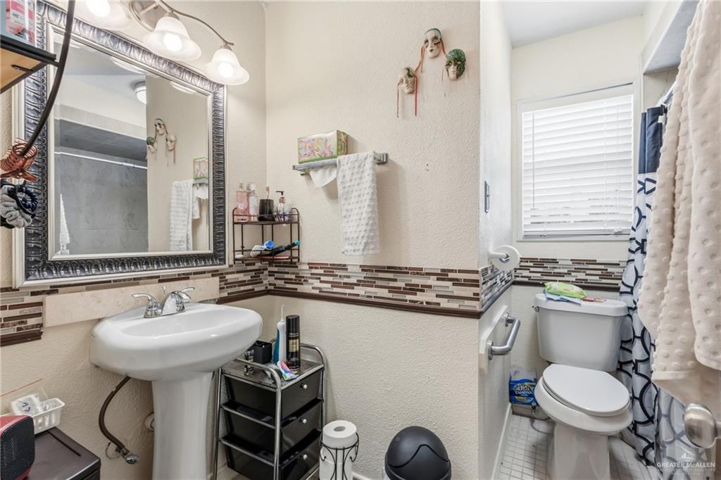 2124 Hawk Avenue McAllen, TX 78504 - Photo 11 of 18 a bathroom with a sink toilet and mirror