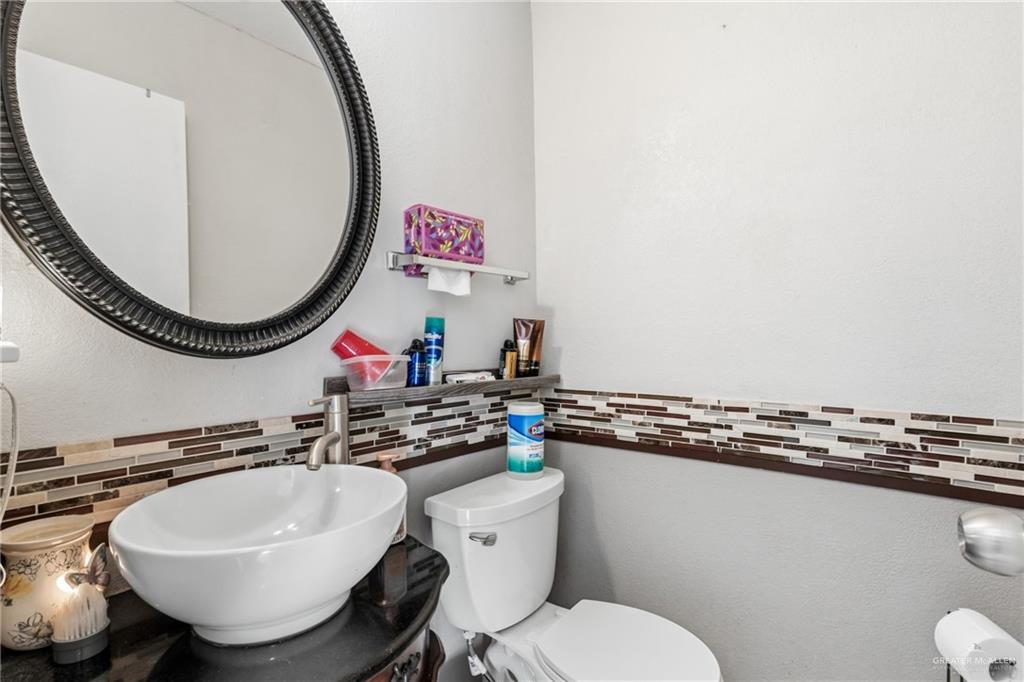 2124 Hawk Avenue McAllen, TX 78504 - Photo 12 of 18 a bathroom with a sink mirror vanity and toilet