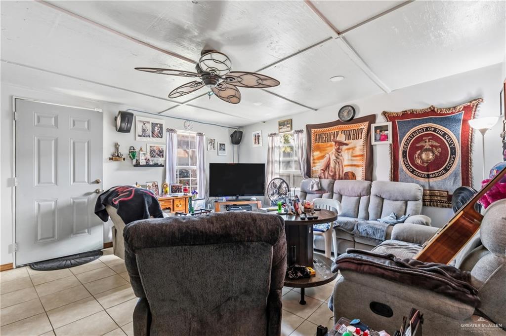 2124 Hawk Avenue McAllen, TX 78504 - Photo 14 of 18 a living room with furniture a flat screen tv and a window