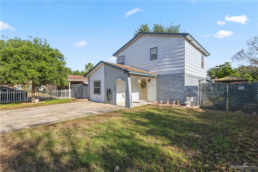 2124 Hawk Avenue McAllen, TX 78504 - Photo 2 of 18 a front view of house with yard and trees in the background