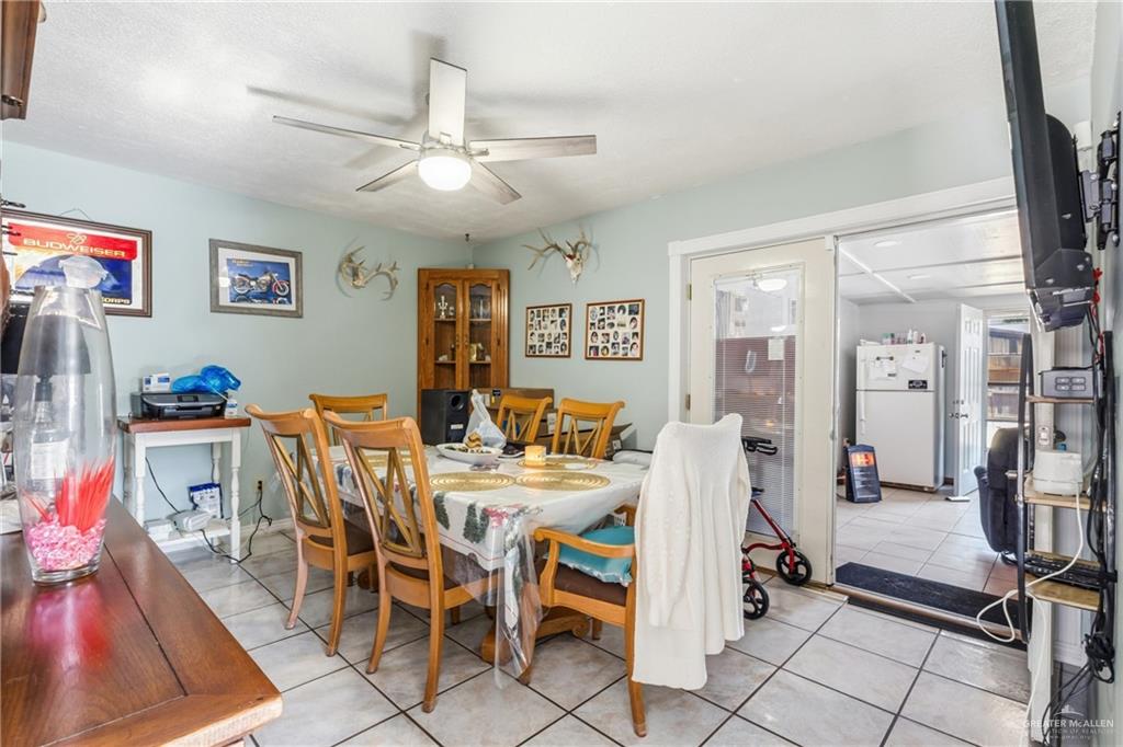 2124 Hawk Avenue McAllen, TX 78504 - Photo 5 of 18 a view of a dining room with furniture and a chandelier