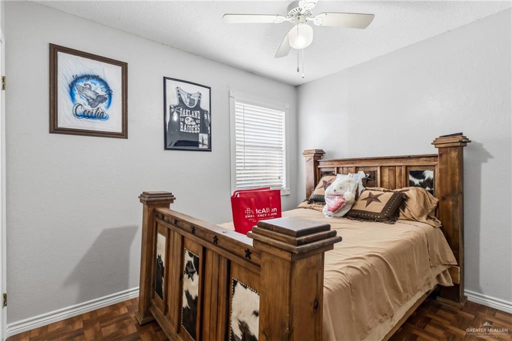 2124 Hawk Avenue McAllen, TX 78504 - Photo 9 of 18 a bedroom with bed and paintings on the wall