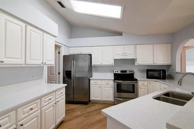 a kitchen with a sink a stove and refrigerator