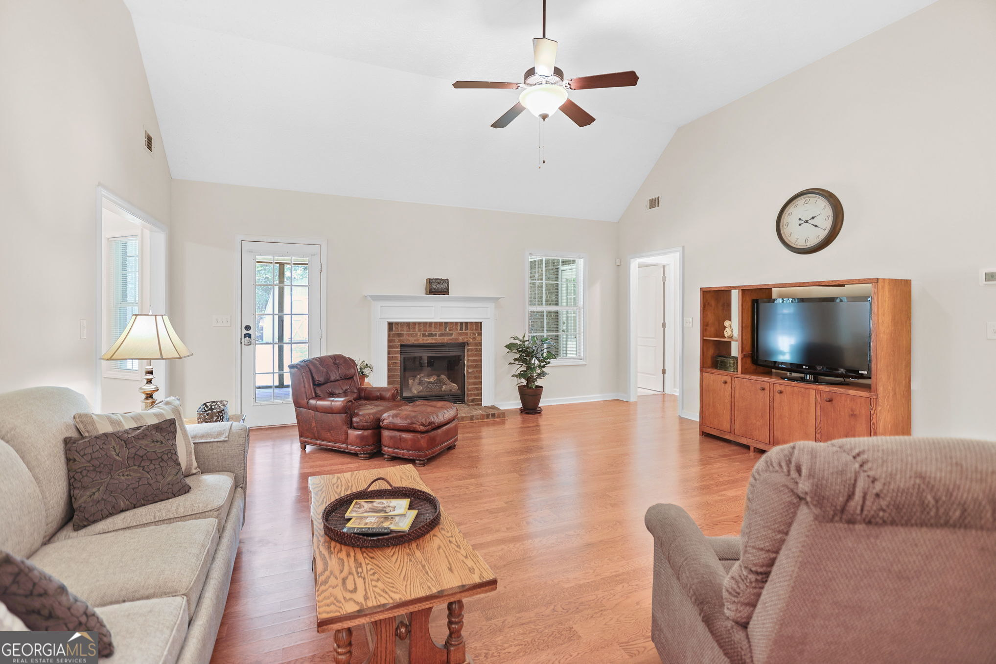 892 Brooks Woolsey Road Brooks, GA 30205 - Photo 34 of 45 a living room with furniture a flat screen tv and a fireplace