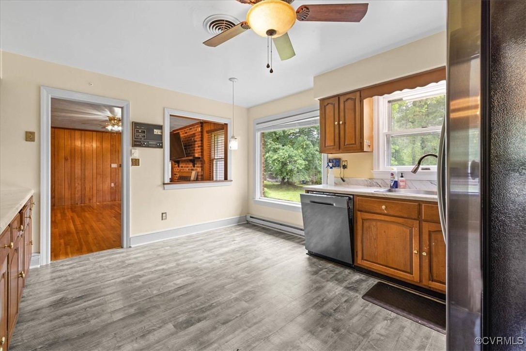448 Jasper Lane Waverly, VA 23890 - Photo 15 of 44 a room with kitchen island a sink a stove and a large window