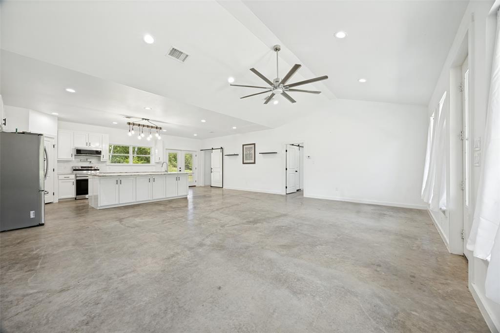 822 Private Road 7370 Point, TX 75472 - Photo 12 of 30 Spacious open-concept interior featuring concrete flooring, a vaulted ceiling, and recessed lighting