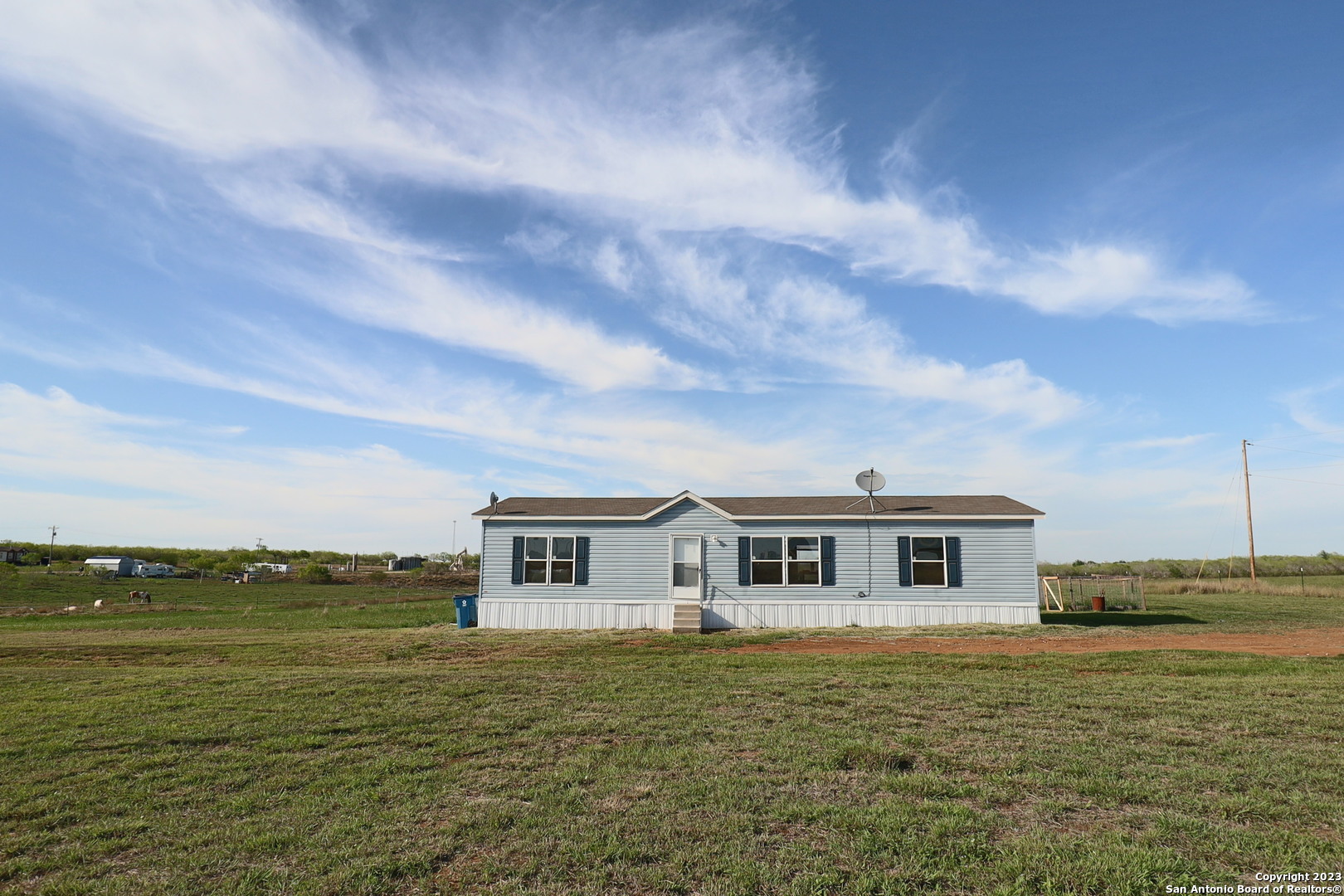 357 Persimmon Drive Pleasanton, TX 78064 - Photo 1 of 1 a front view of a house with a garden