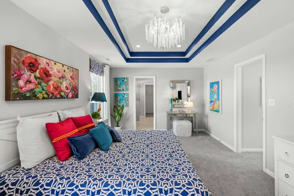 a bedroom with furniture and a chandelier