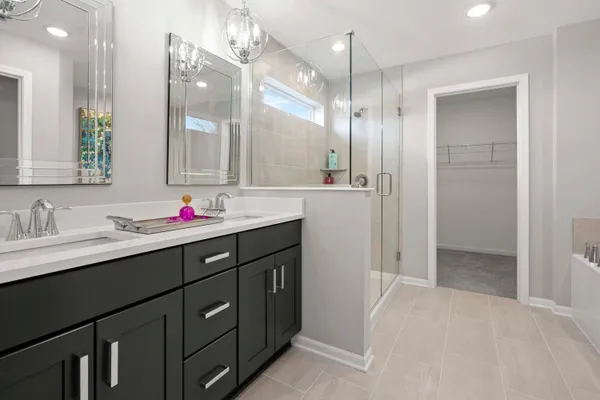a bathroom with a shower sink vanity and mirror