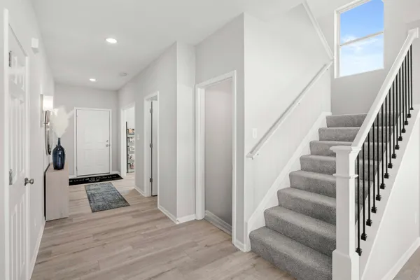 a view of an entryway with wooden floor and staircase