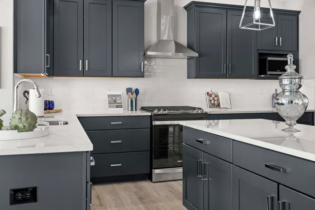 a kitchen with a sink cabinets and wooden floor