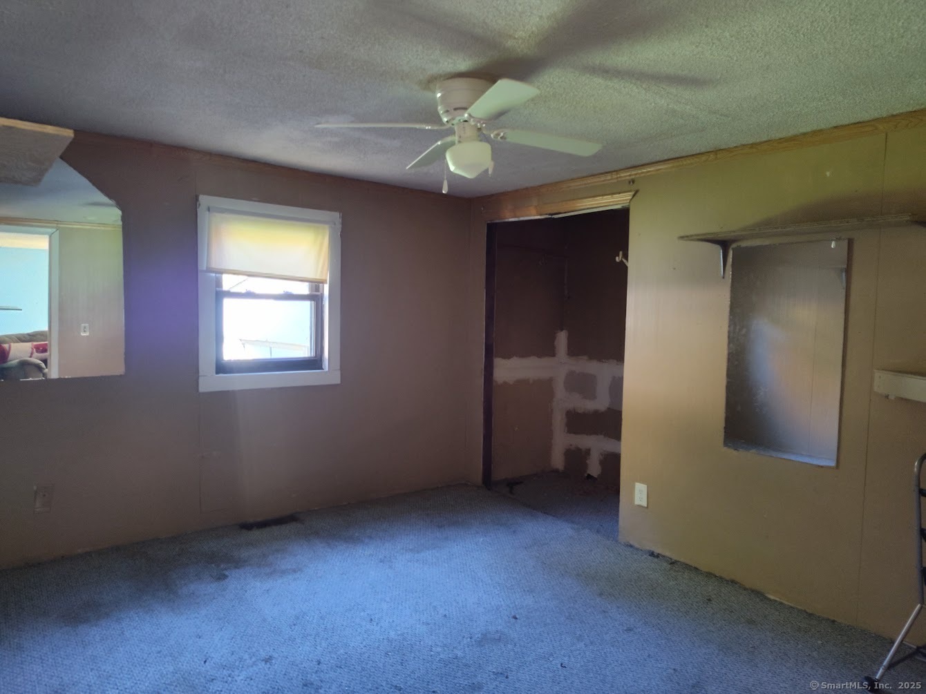 155 Iron Street Ledyard, CT 06339 - Photo 13 of 17 an empty room with windows and fan