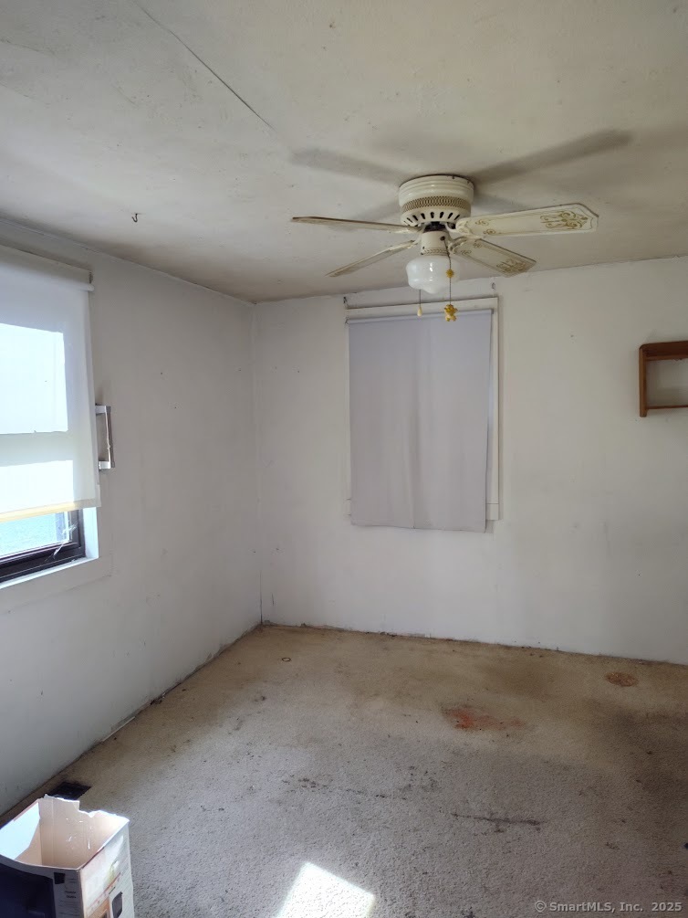 155 Iron Street Ledyard, CT 06339 - Photo 14 of 17 an empty room with a ceiling fan and window