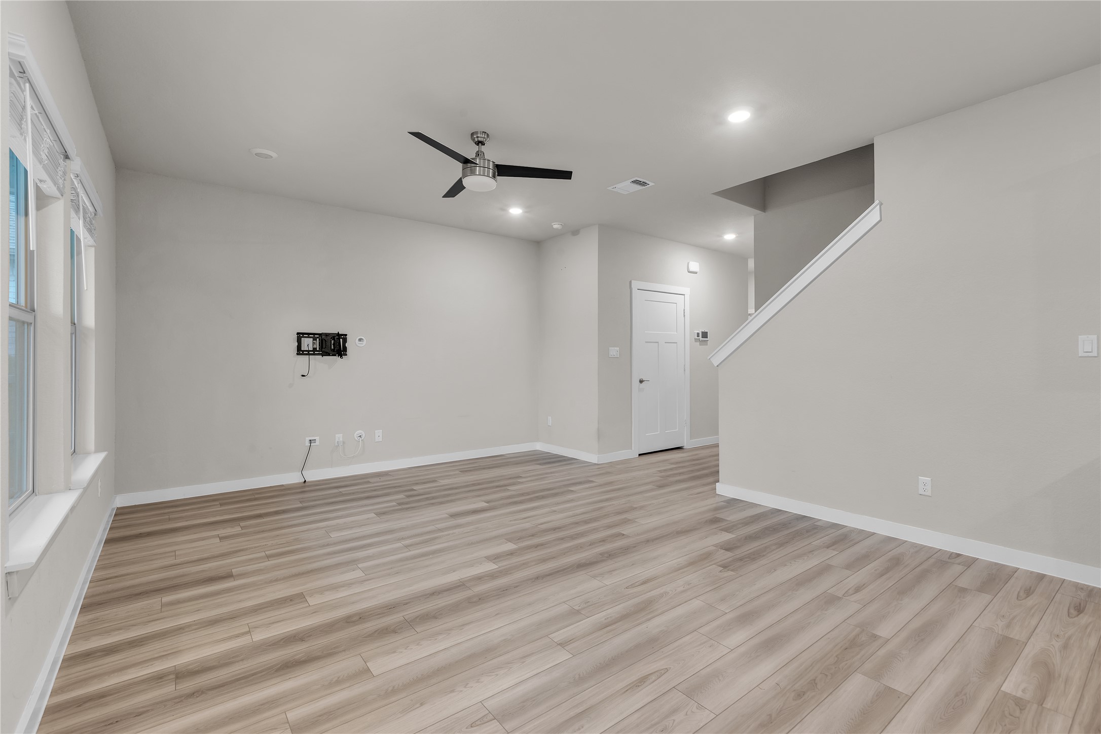 1212 Tipton Street Georgetown, TX 78633 - Photo 3 of 20 A generous living area features modern light-toned flooring and an open stairway.