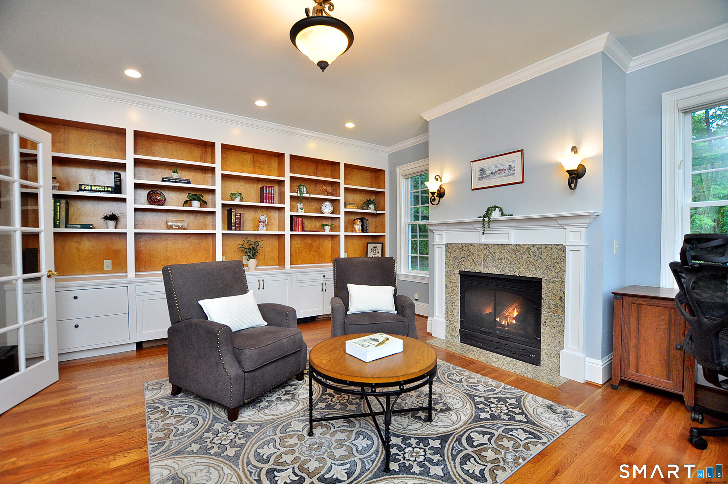 15 Old Orchard Road Granby, CT 06090 - Photo 14 of 40 Built in bookcases and cabinetry and a cosy spot to relax in front of the fire!