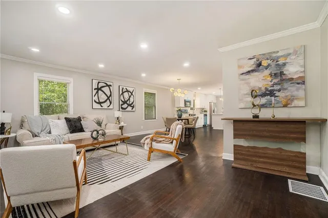 a living room with furniture and wooden floor