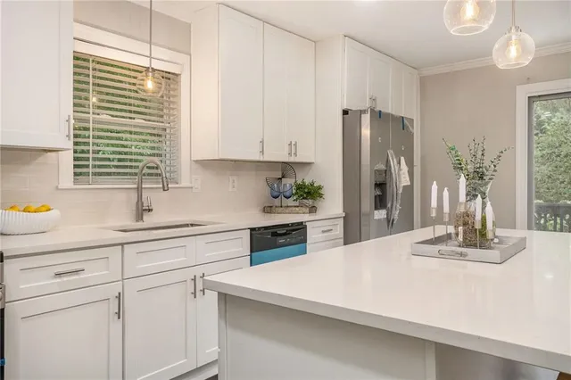a kitchen with kitchen island white cabinets and white appliances
