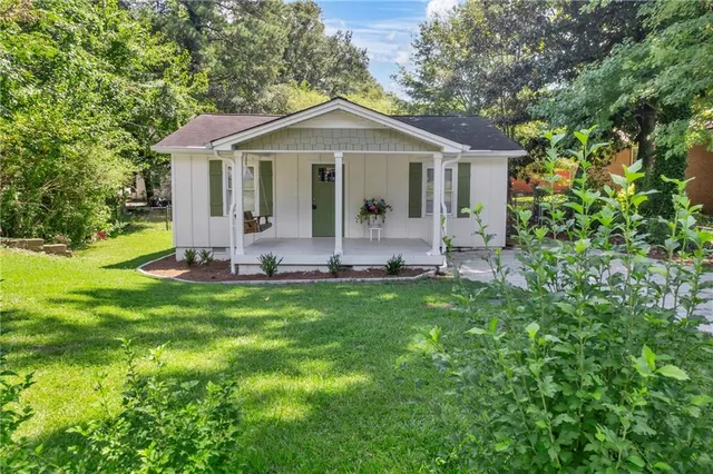 a front view of a house with a yard and porch
