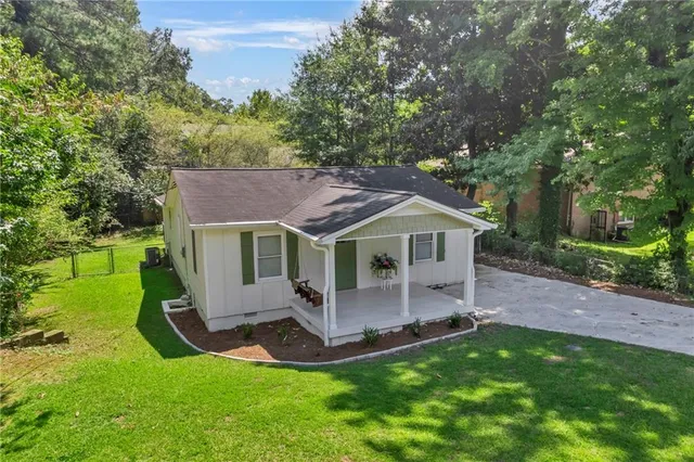 an aerial view of a house with a yard deck and a patio