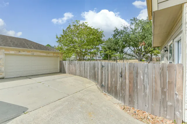 a view of a small space with wooden fence