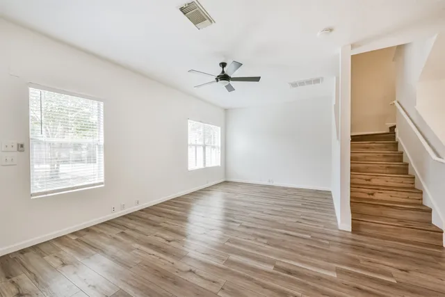 wooden floor in an empty room with a window