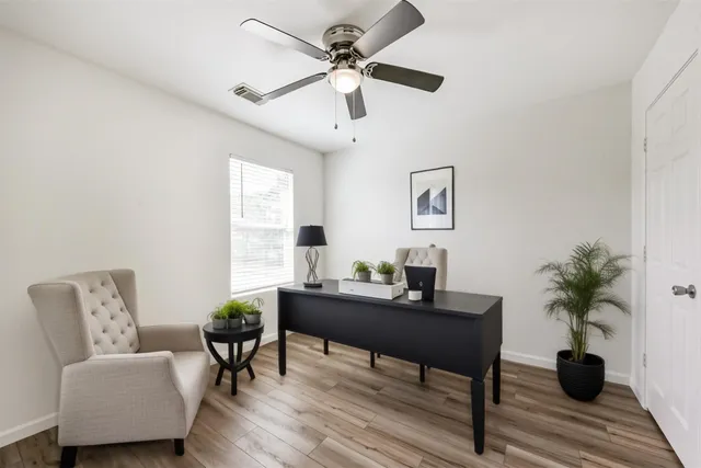 a workspace with furniture and a potted plant