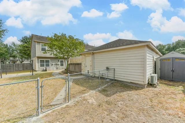 a view of a house with backyard and sitting area