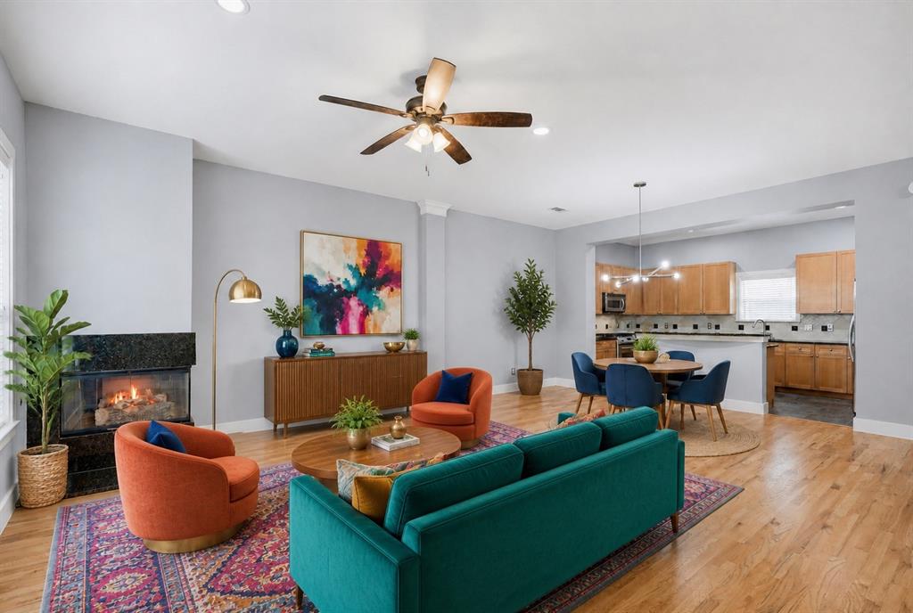 4830 Cedar Springs Road, Unit 30 Dallas, TX 75219 - Photo 6 of 32 Living area with a built-in fireplace featuring a dark stone surround, wood-finish flooring, recessed lighting, and a ceiling fan