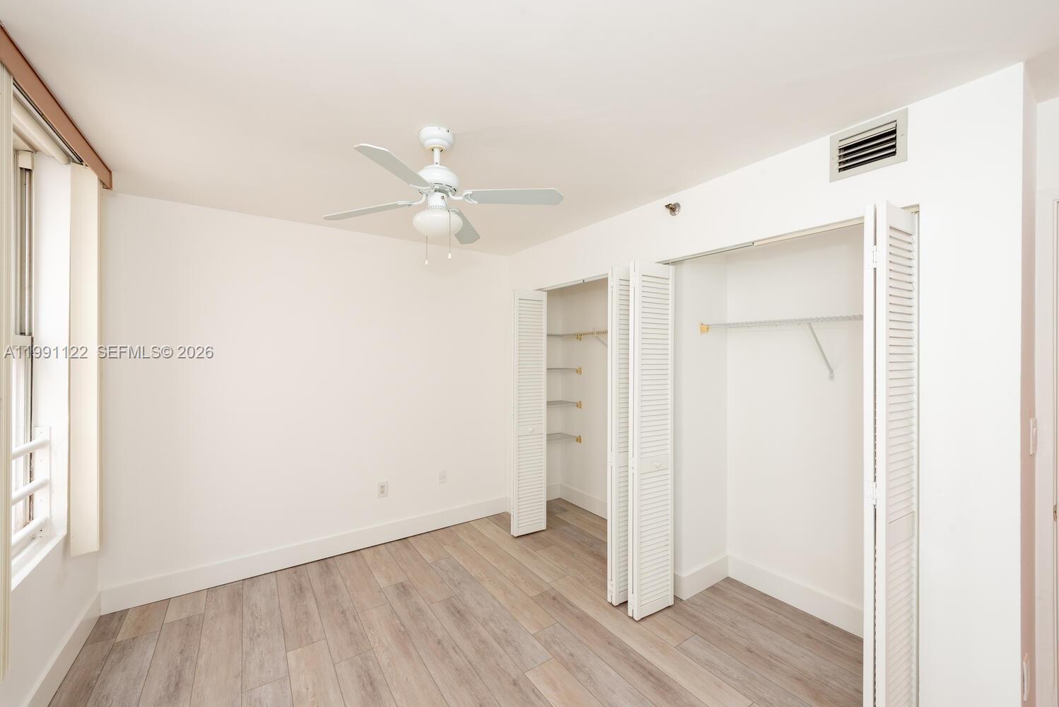 2801 Florida Avenue, Unit 441 Miami, FL 33133 - Photo 13 of 24 an empty room with wooden floor and window