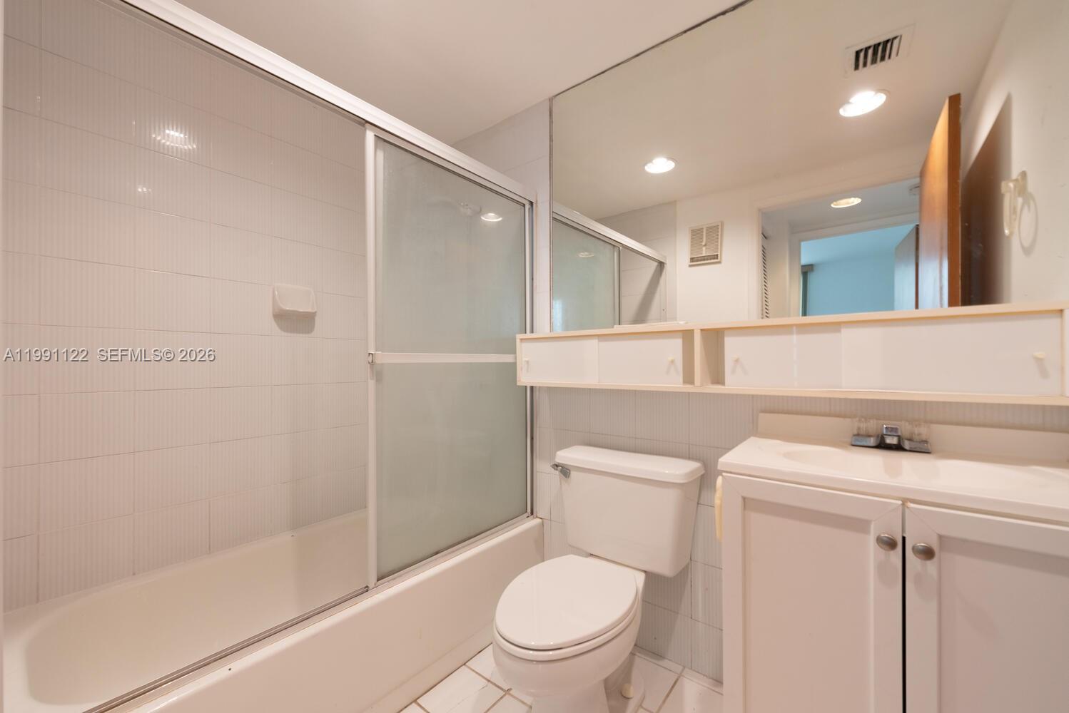 2801 Florida Avenue, Unit 441 Miami, FL 33133 - Photo 15 of 24 a bathroom with a toilet a sink and a shower