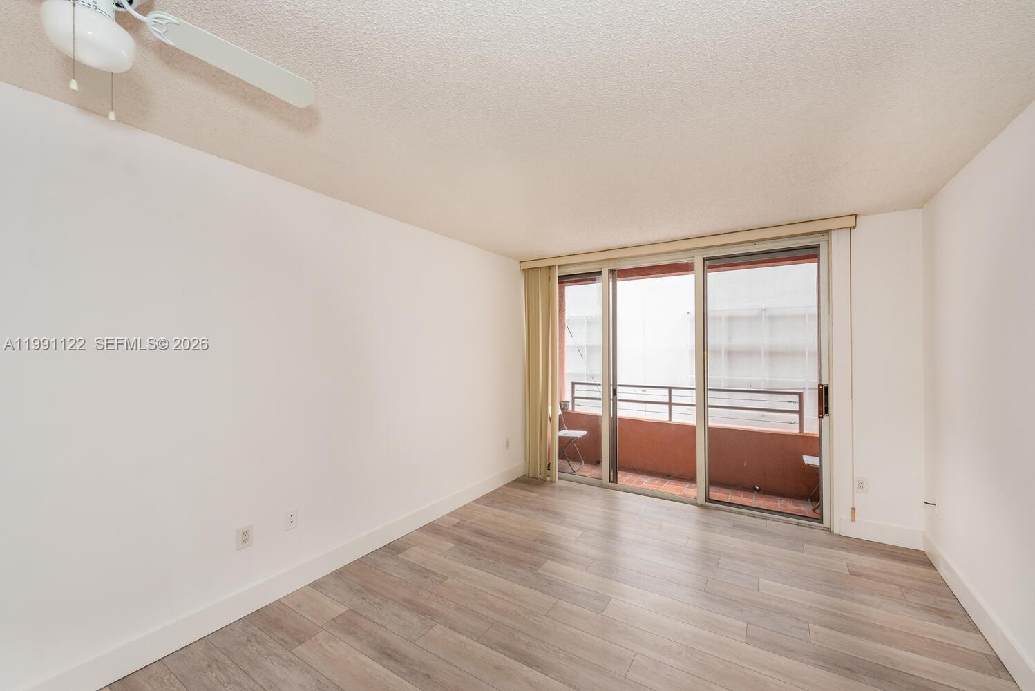 2801 Florida Avenue, Unit 441 Miami, FL 33133 - Photo 4 of 24 wooden floor in an empty room with a window