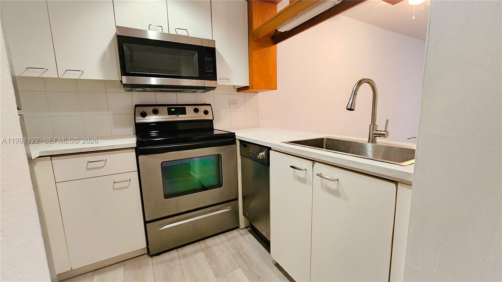 2801 Florida Avenue, Unit 441 Miami, FL 33133 - Photo 9 of 24 a kitchen with stainless steel appliances white cabinets a sink and a stove