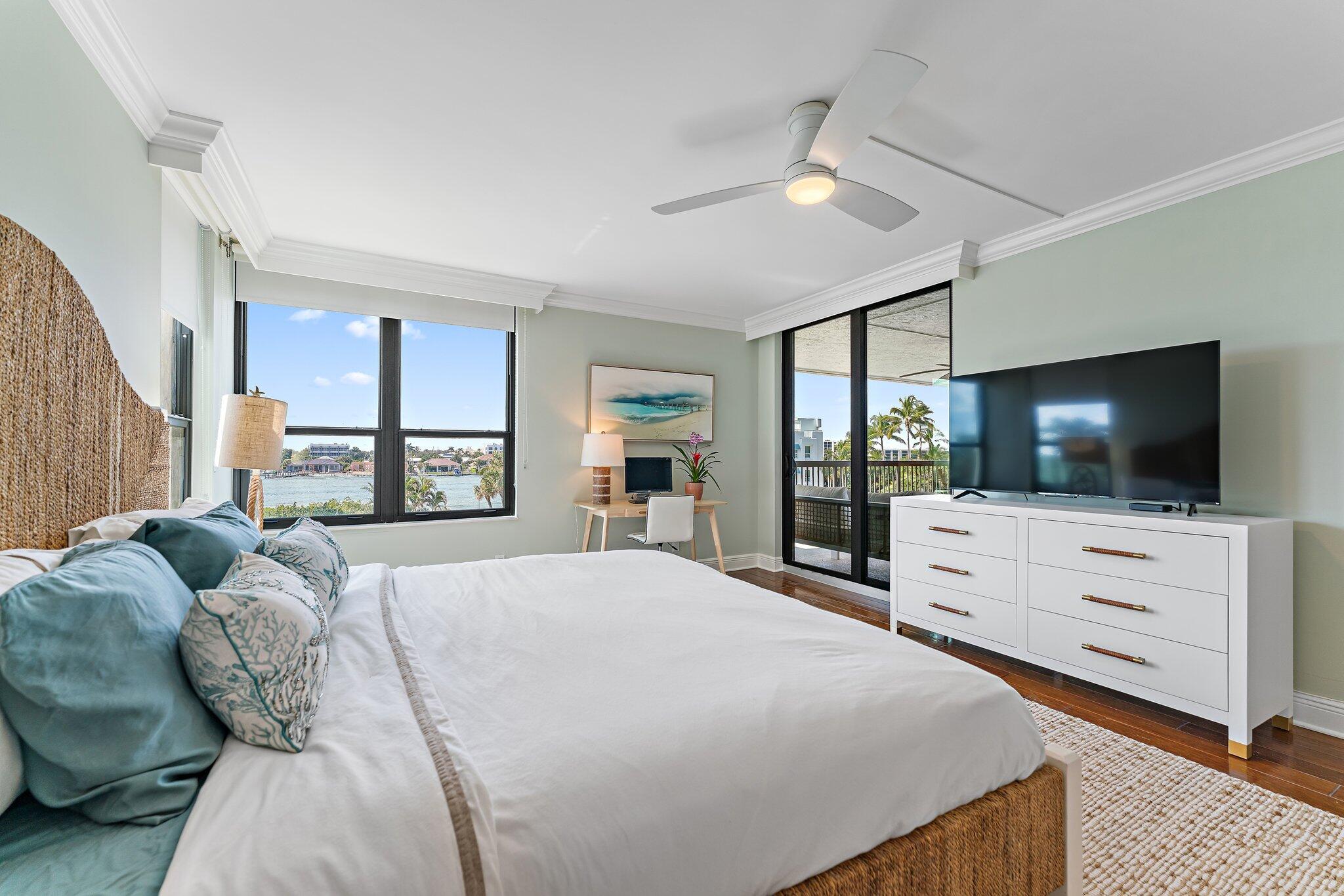19670 South Beach Road, Unit B303 Jupiter, FL 33469 - Photo 42 of 104 a large bedroom with a bed and flat screen tv