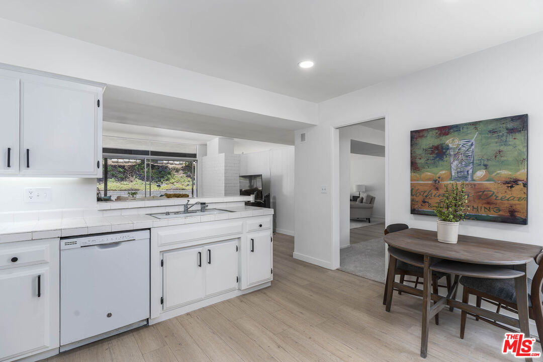 4139 Magna Carta Road Calabasas, CA 91302 - Photo 12 of 33 a view of a kitchen area with furniture and wooden floor