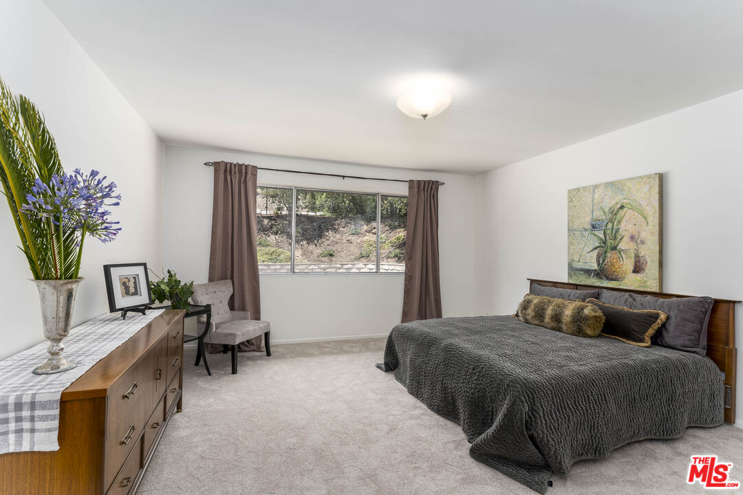 4139 Magna Carta Road Calabasas, CA 91302 - Photo 15 of 33 a bedroom with a bed table and a window