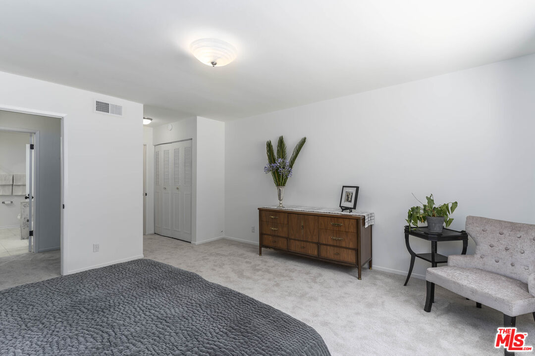 4139 Magna Carta Road Calabasas, CA 91302 - Photo 16 of 33 a bedroom with furniture and a potted plant
