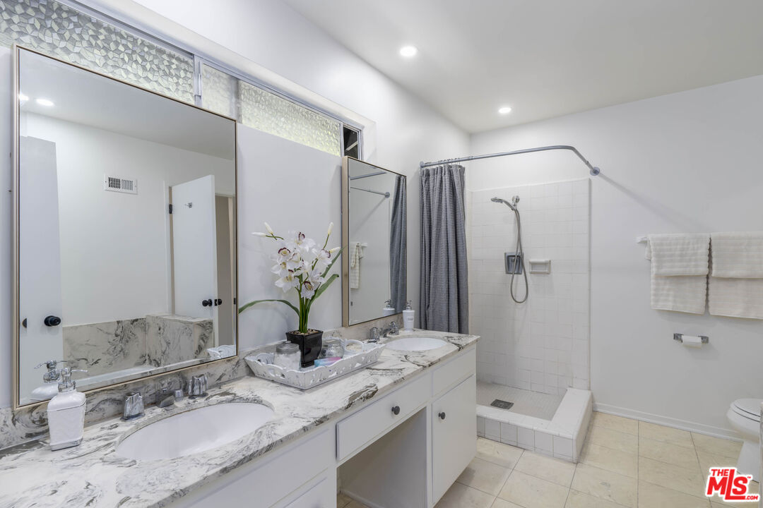 4139 Magna Carta Road Calabasas, CA 91302 - Photo 19 of 33 a bathroom with a granite countertop sink toilet and shower