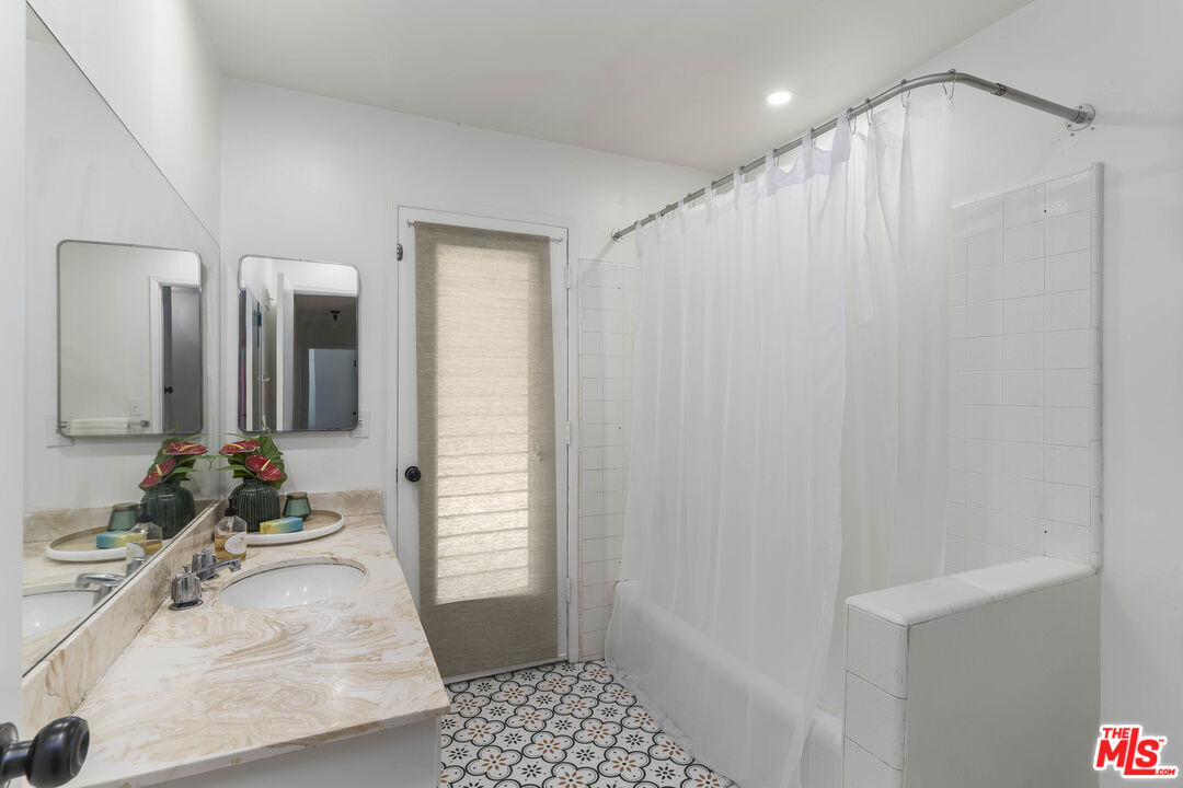 4139 Magna Carta Road Calabasas, CA 91302 - Photo 22 of 33 a bathroom with a sink and a mirror