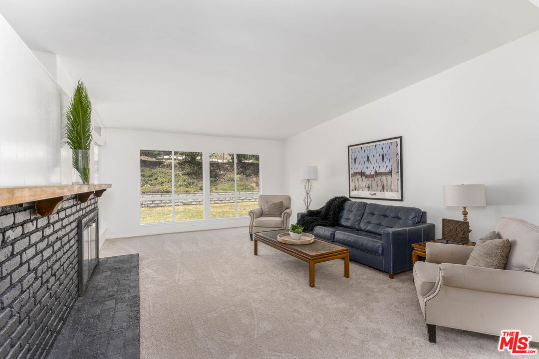 4139 Magna Carta Road Calabasas, CA 91302 - Photo 7 of 33 a living room with furniture and a large window