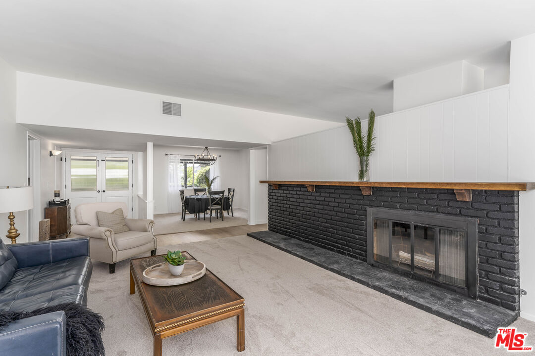 4139 Magna Carta Road Calabasas, CA 91302 - Photo 8 of 33 a living room with furniture and a fireplace