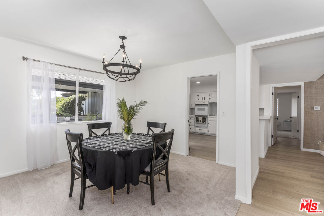 4139 Magna Carta Road Calabasas, CA 91302 - Photo 9 of 33 a dining room with furniture a chandelier and wooden floor
