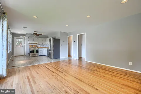 a view of kitchen and hall with wooden floor