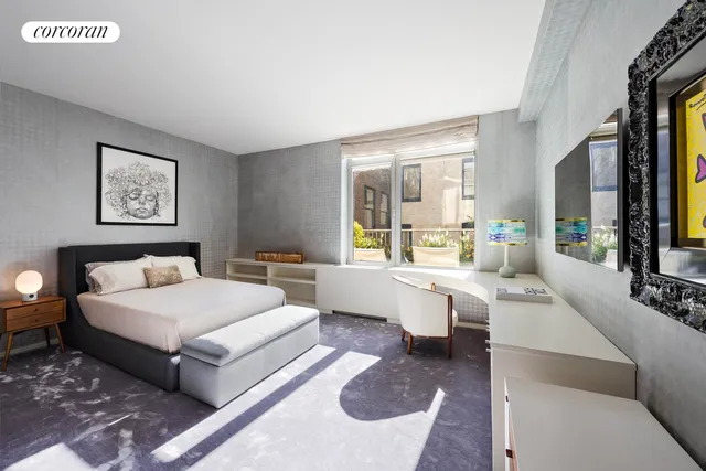 a bedroom with a bed and a potted plant