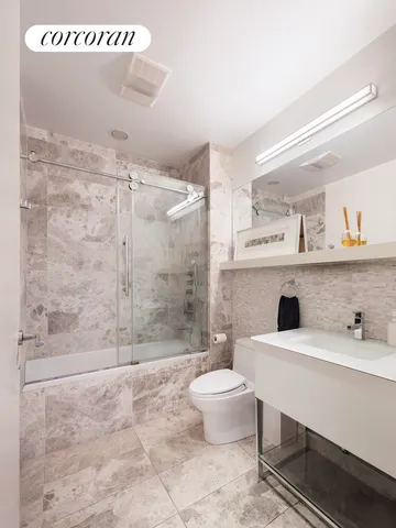 a bathroom with a toilet a sink and mirror