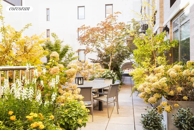a view of a patio with table and chairs and potted plants